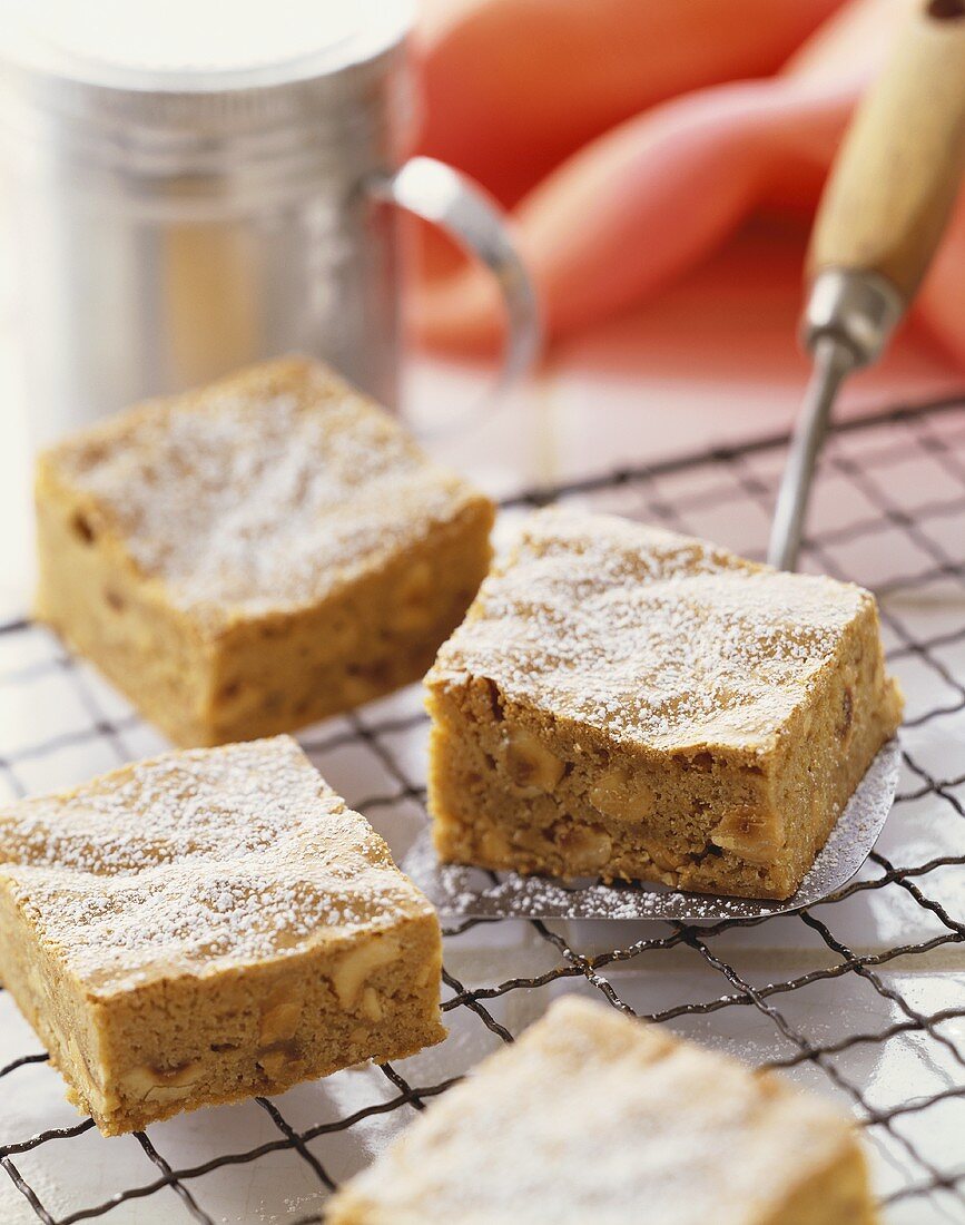 Macadamia Nut Bars Dusted with Powdered Sugar on a Cooling Rack