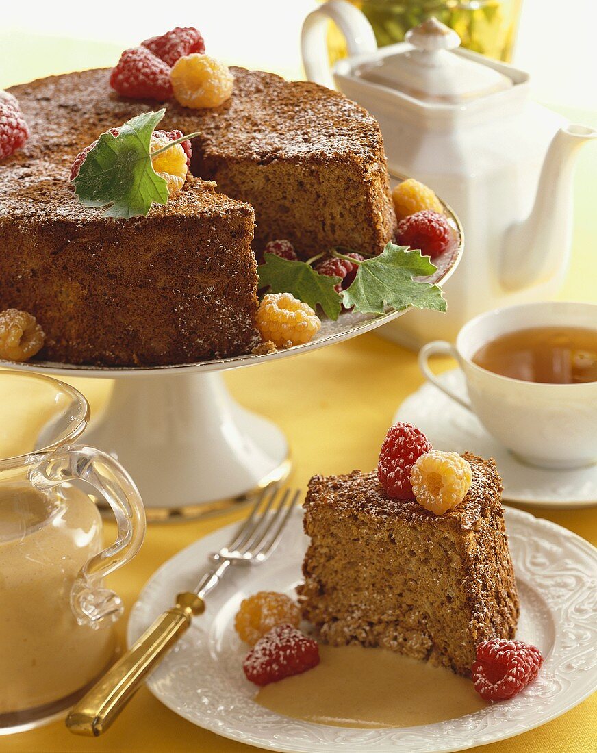 Slice of Spice Cake with Red and Golden Raspberries in Bourbon Sauce, Whole Cake with Slice Removed