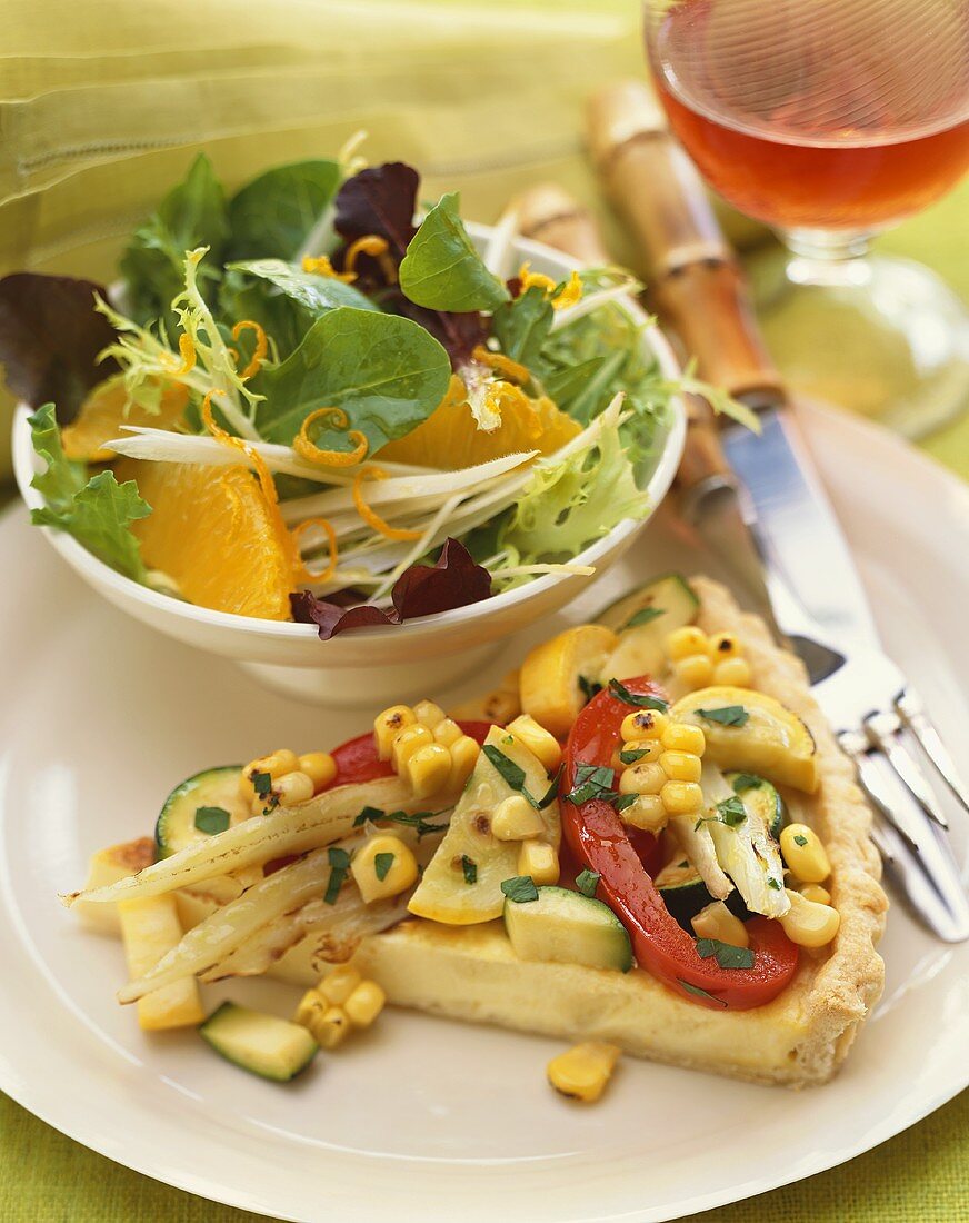 Slice of Vegetable Tart with Corn, Zucchini, Fennel and Peppers, Side Salad