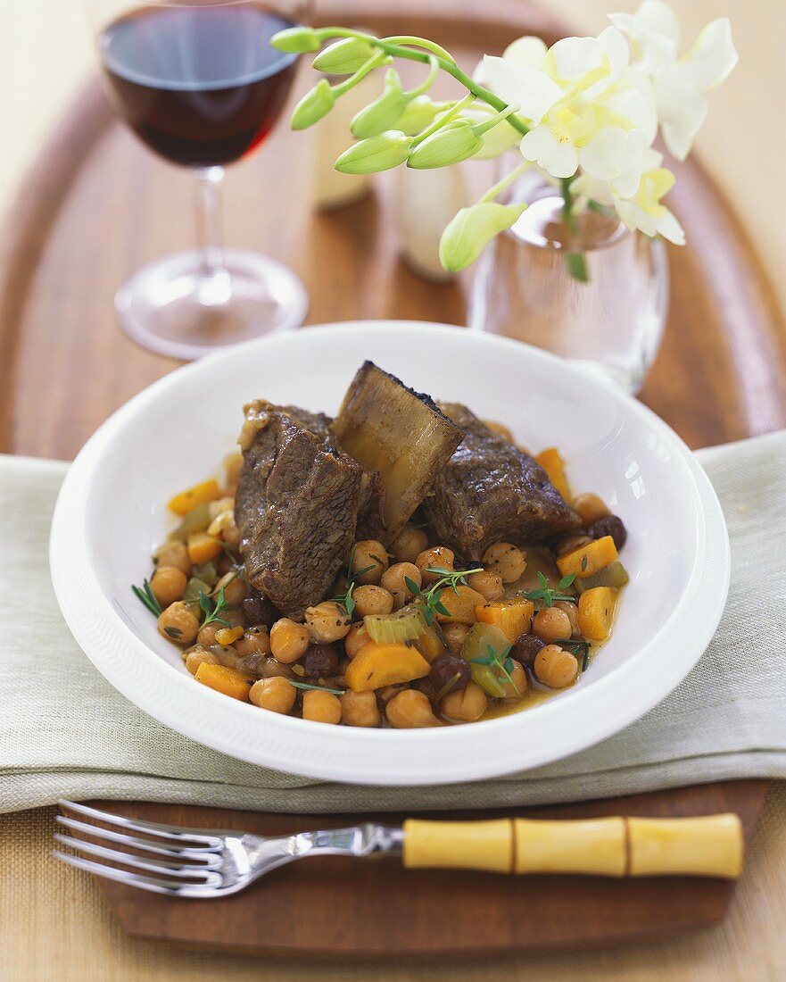 Short Ribs with Garbanzo Beans and Raisins in a White Bowl, Bamboo Fork