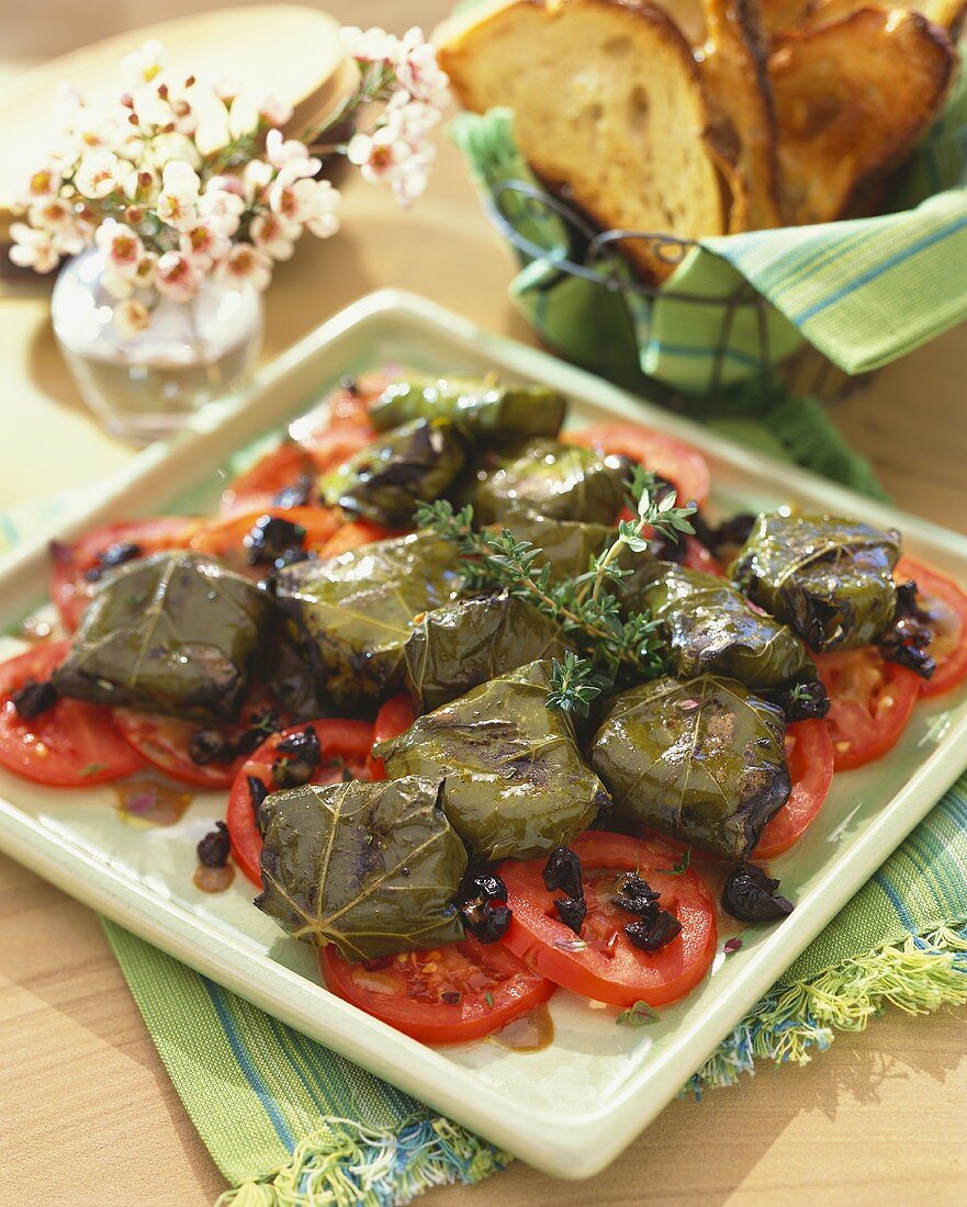 Platter of Goat Cheese Wrapped in Grape Leaves on Sliced Tomatoes