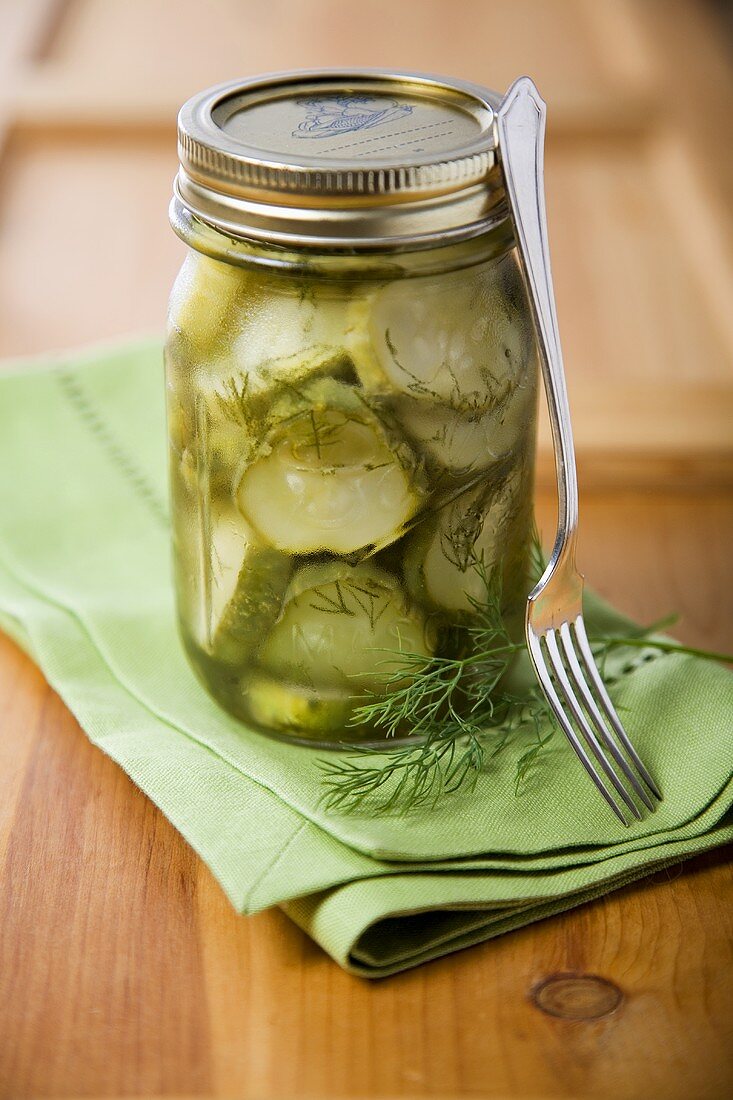 Jar of Homemade Pickles with Fresh Dill and a Fork