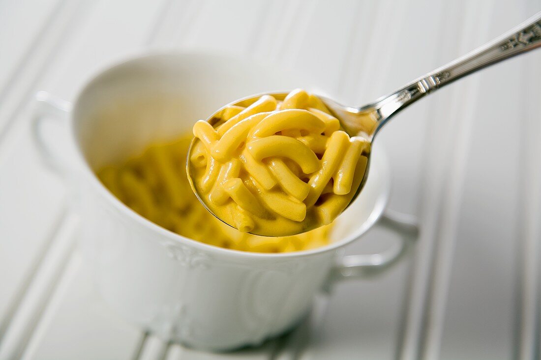 Spoonful of Macaroni and Cheese Above a Bowl