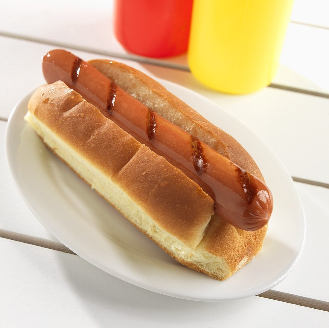 Grilled Hot Dog in a Bun; Plain; Ketchup and Mustard Bottles