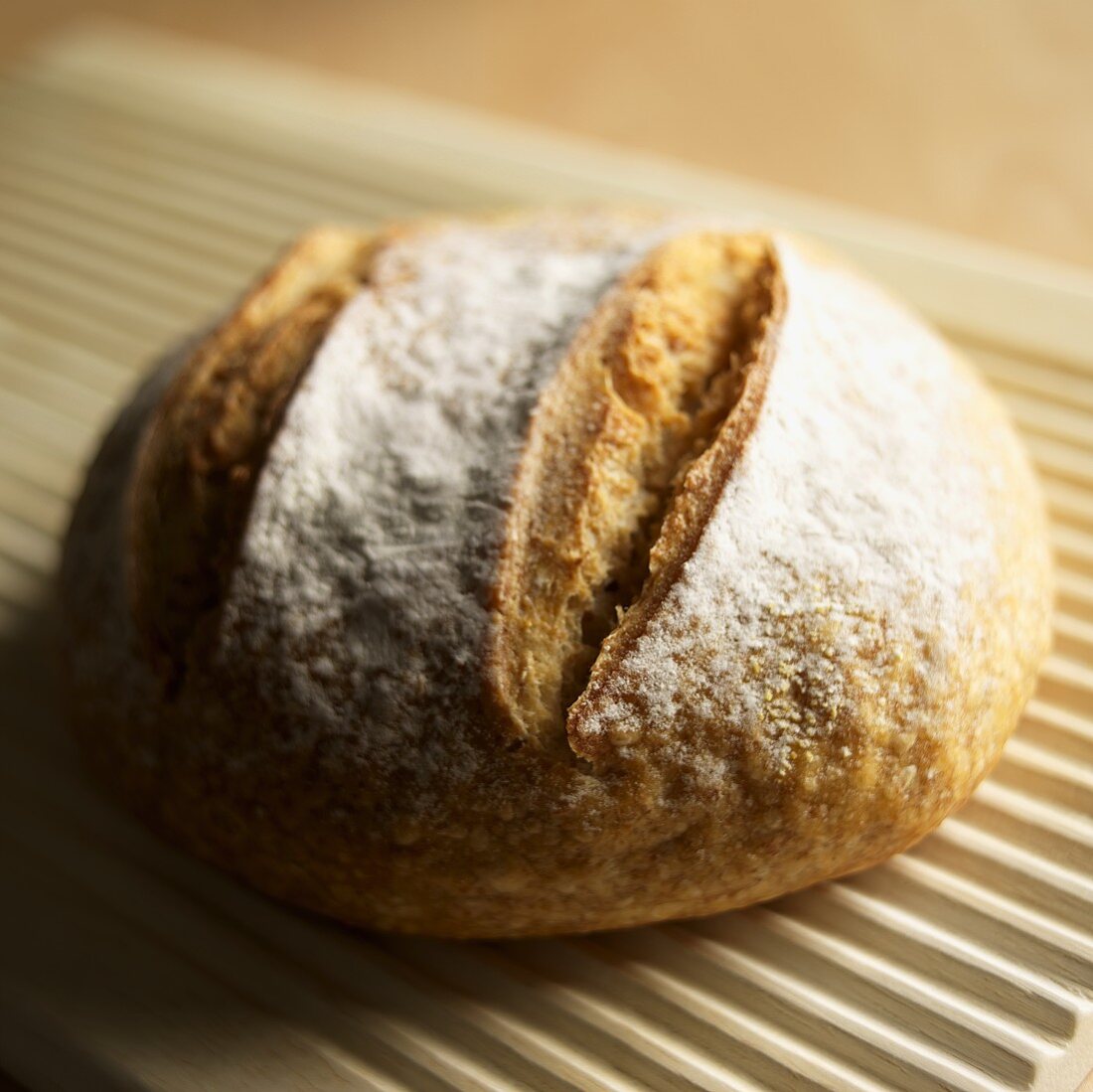 Loaf of Rustic Bread on a Bread Board