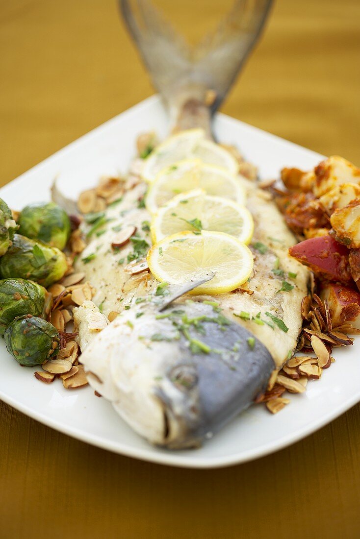 Whole Pompano Fish with Brussels Sprouts and Potatoes on a Platter