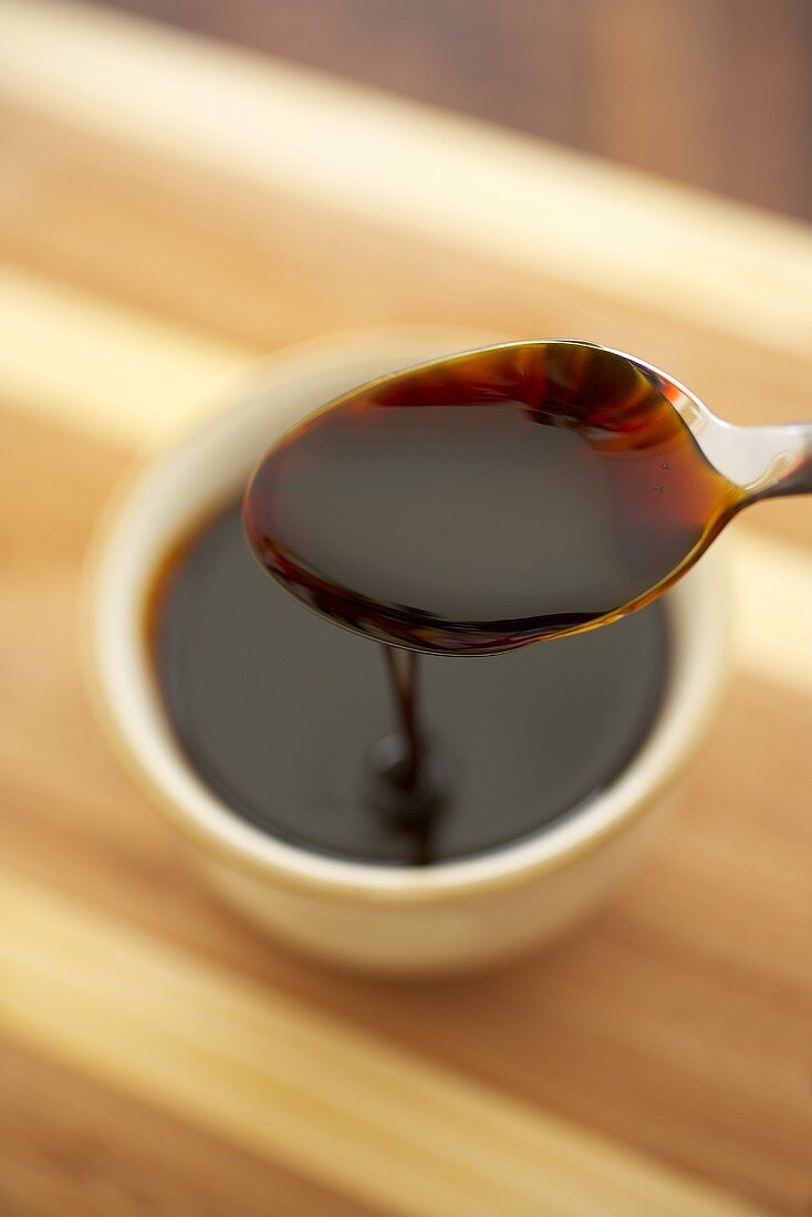 Spoonful of Sorghum Syrup Over a Cup