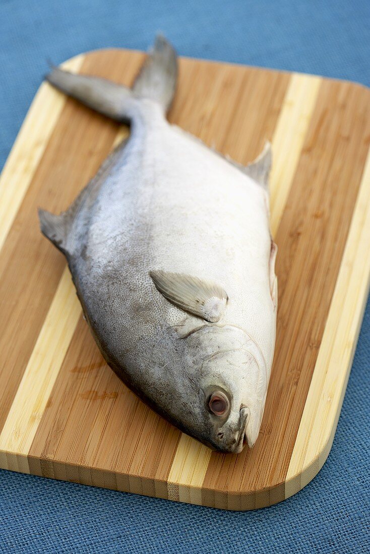 Whole Pompano Fish on a Cutting Board