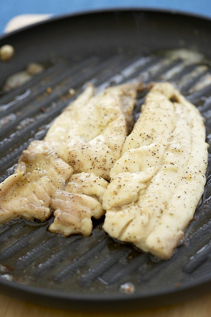 Two Pompano Fish Fillets on a Grill Pan