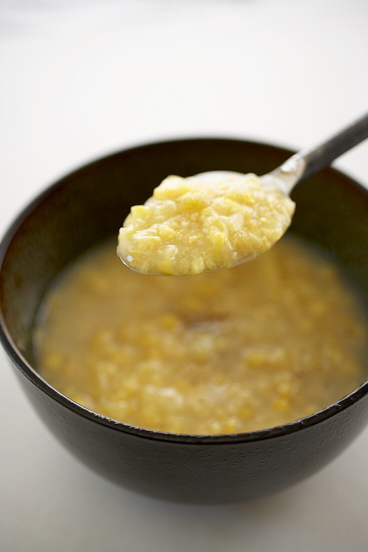 Spoonful of Creamed Corn Over a Bowl of Creamed Corn