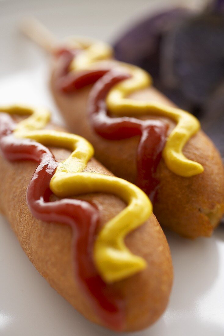 Two Corn Dogs with Mustard and Ketchup; Close Up