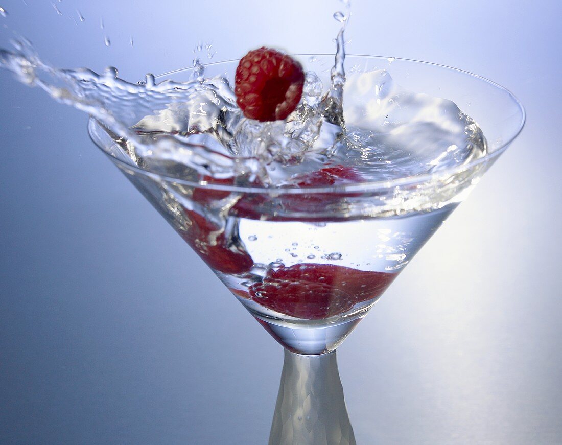 Raspberries Splashing into a Martini
