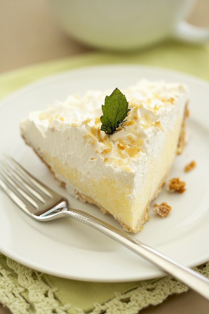 Slice of Coconut Cream Pie on a White Plate with Fork