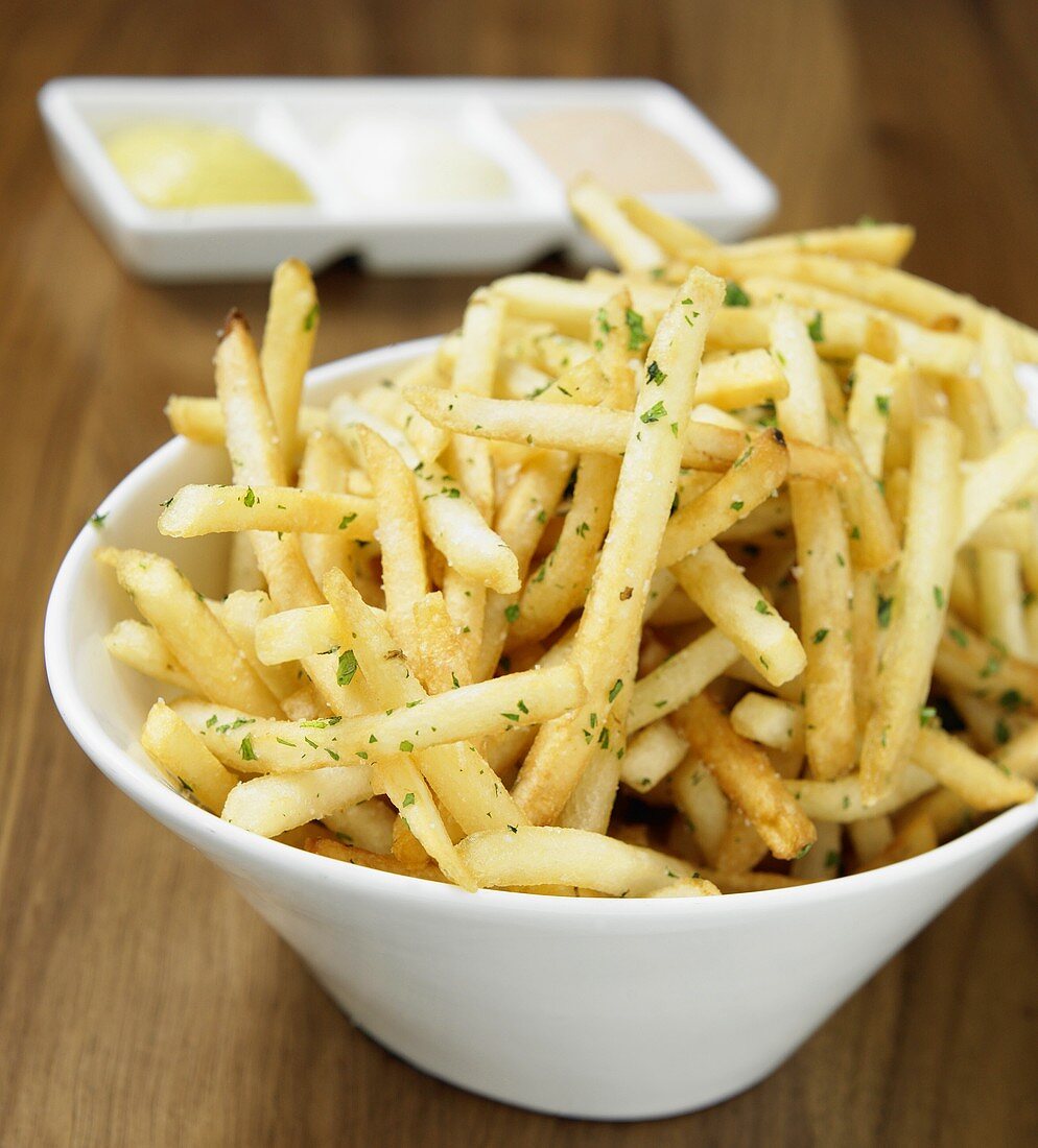 French Fries in White Bowl with Various Dips