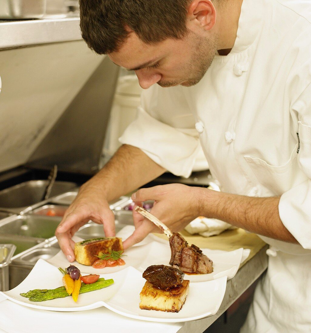 Chef Plating Food in a Restaurant Kitchen