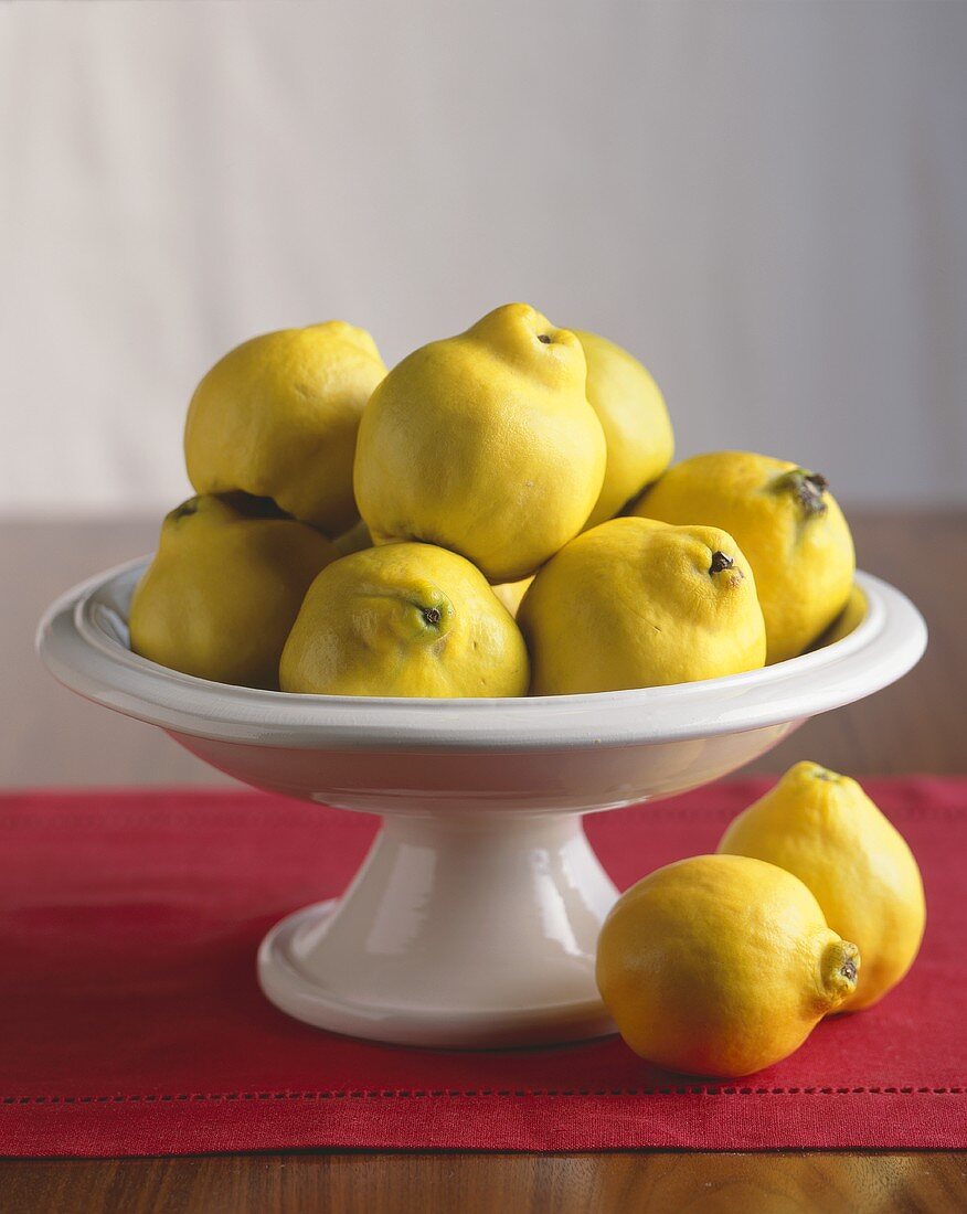 Fresh Quince In and Beside a Pedestal Dish