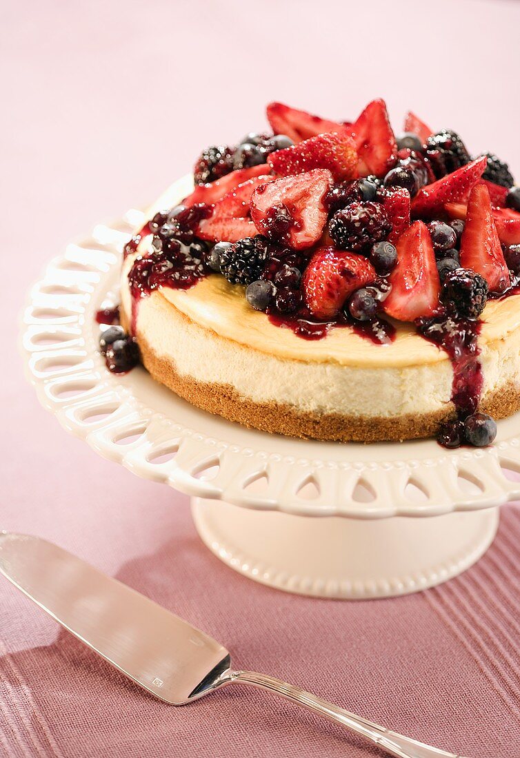 Cheesecake Topped with Assorted Berries on a Cake Plate