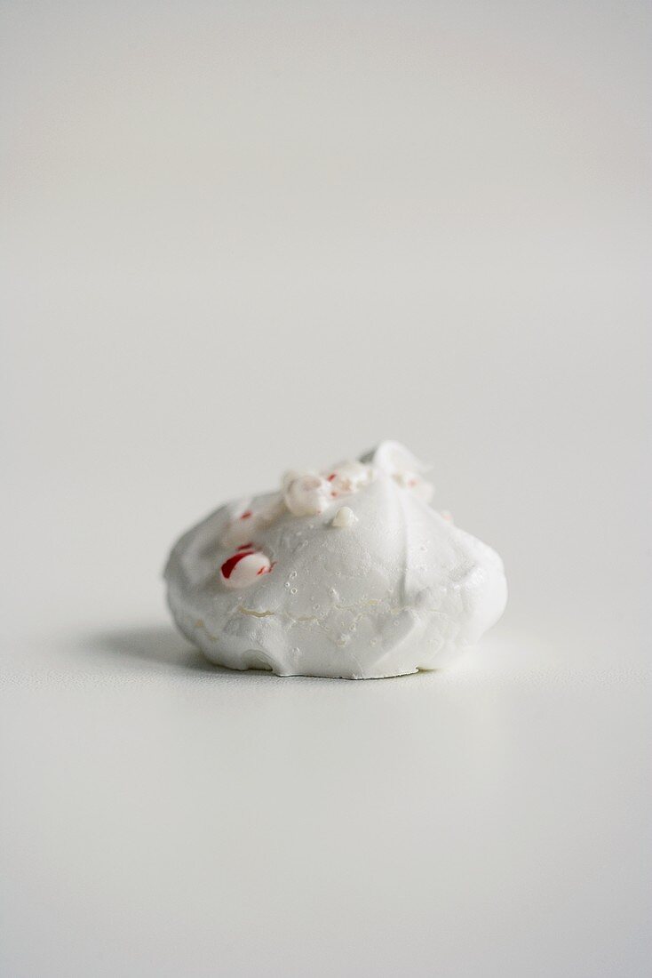 A Single Meringue Cookie on a White Background