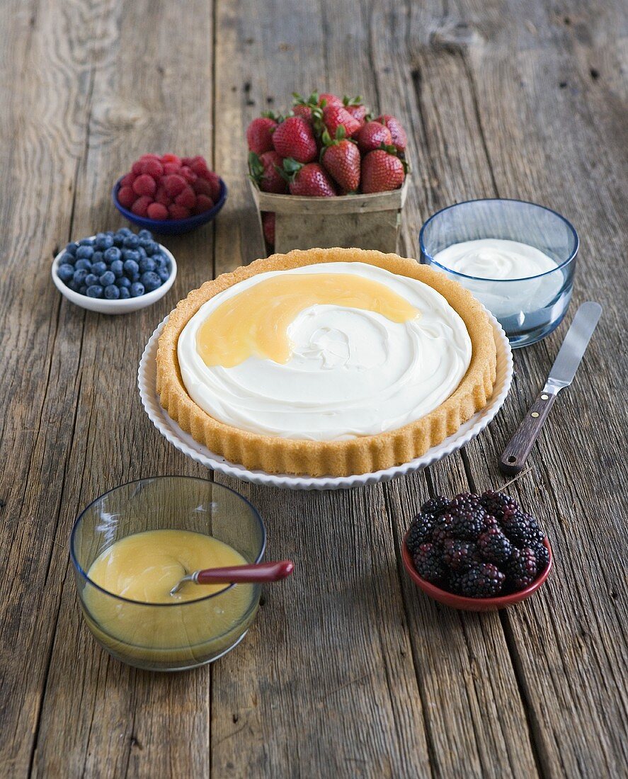 Tart Surrounded by Assorted Berries for Topping; On Wood