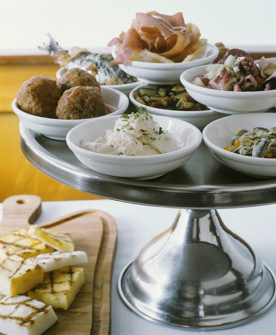 Italian Tapas on a Pedestal Dish; Grilled Polenta, Meatballs, Calamari, Sardines