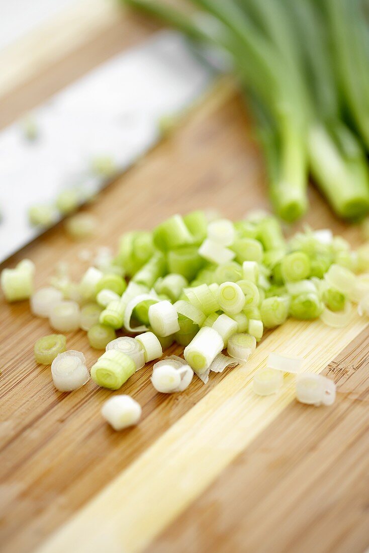 Chopped Green Onion on a Cutting Board, Green Onions and Knife