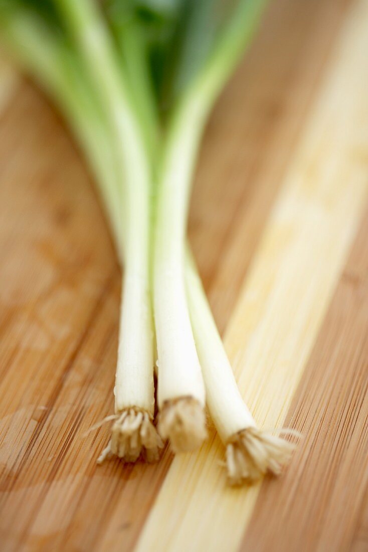 White Ends of Green Onions on a Cutting Board