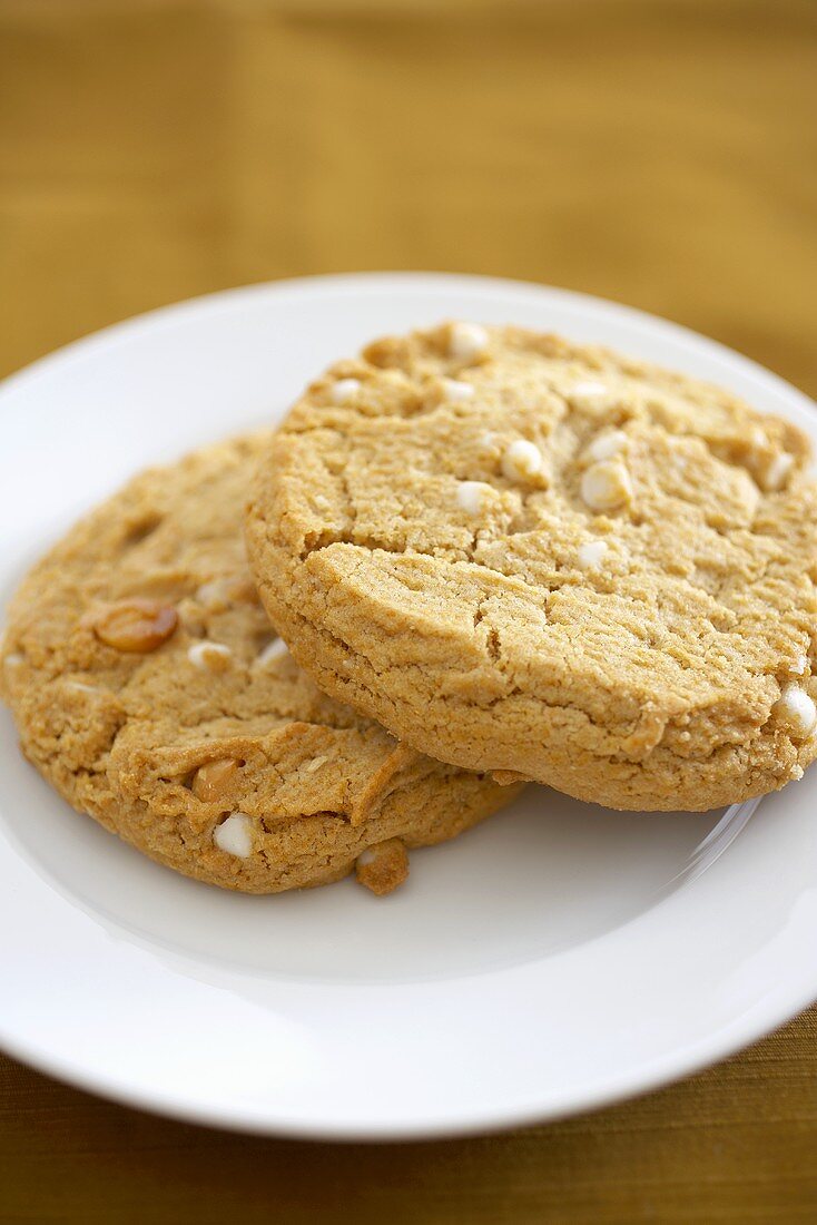Two White Chocolate Chip Cookies with Almonds on a Plate