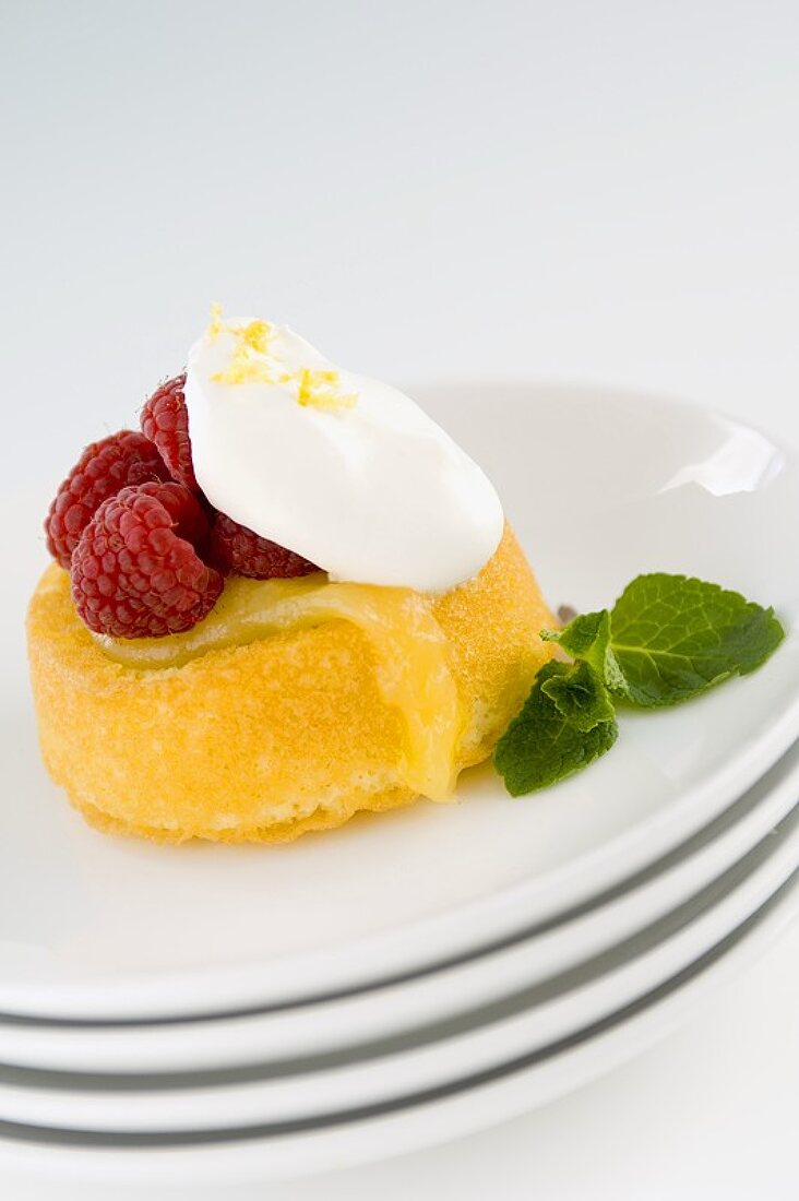 Lemon Filled Spongecake Topped with Raspberries and Whipped Cream