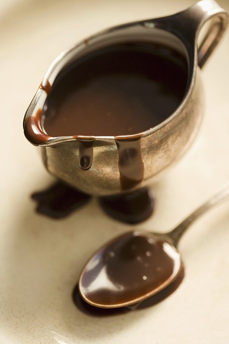 Chocolate Sauce in a Metal Pitcher, Spoon, From Above