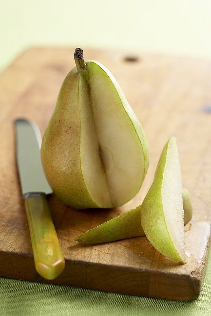 Pear on a Cutting Board with Two Slices Removed, Knife