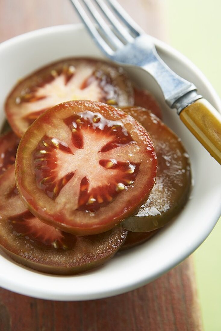 Sliced Rosso Bruno Tomatoes in a Bowl, Fork