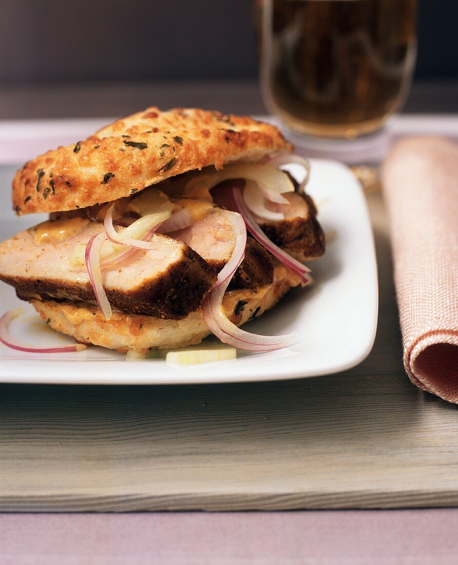 Sliced Pork Sandwich with Red Onion on a Cheese Roll