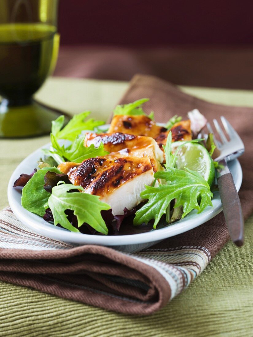 Grilled chicken breast on mizuna salad with lime