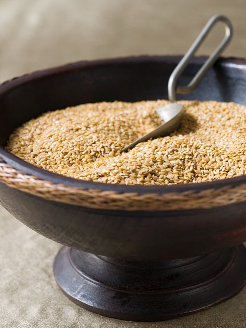 Uncooked brown rice in a wooden bowl