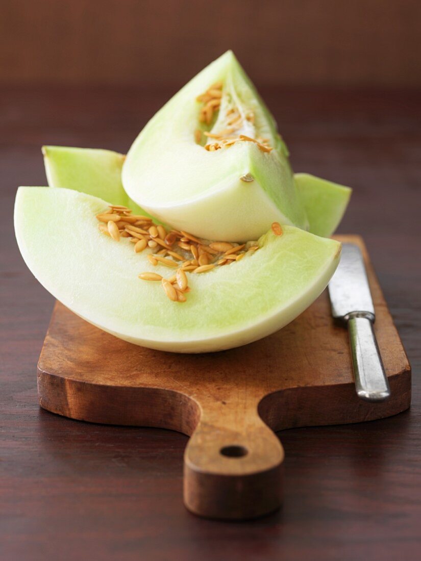 Three wedges of honeydew melon