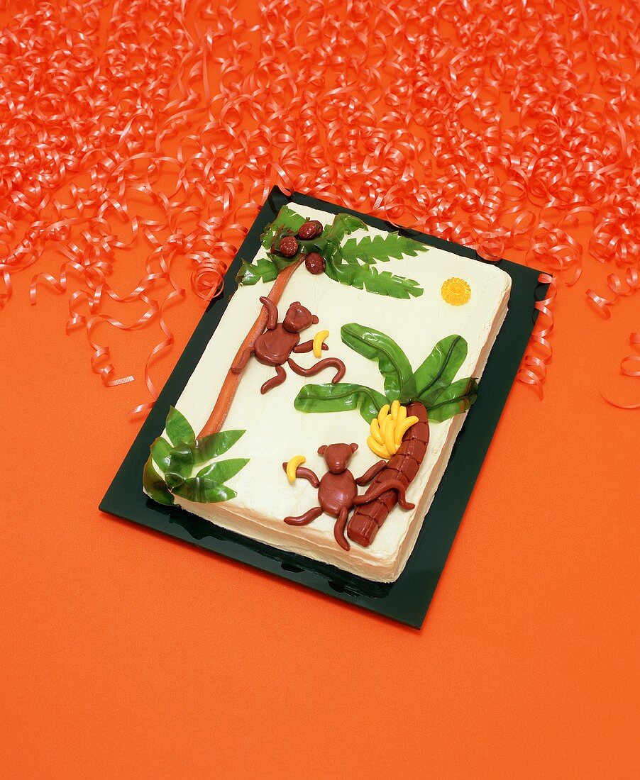 Monkey Cake with Orange Party Ribbons on an Orange Background
