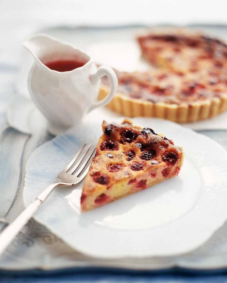 Slice of a Berry Torte on a Plate; Whole Torte