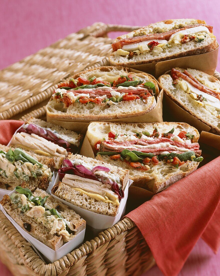 Various Halved Sandwiches in a Picnic Basket