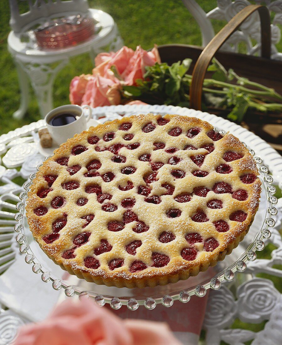 A Raspberry Tart in the Garden with Pink Roses