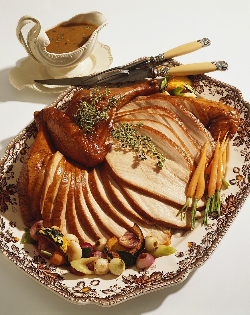 Sliced Roast Turkey on a Platter; Gravy Boat