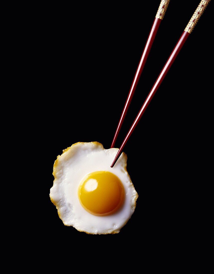 Chopsticks Holding a Fried Egg