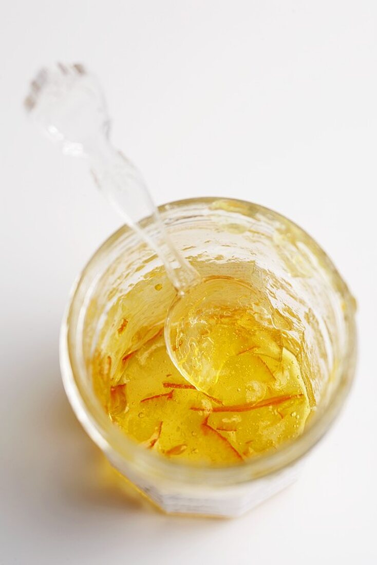 A Jar of Orange Marmalade That is Almost Empty