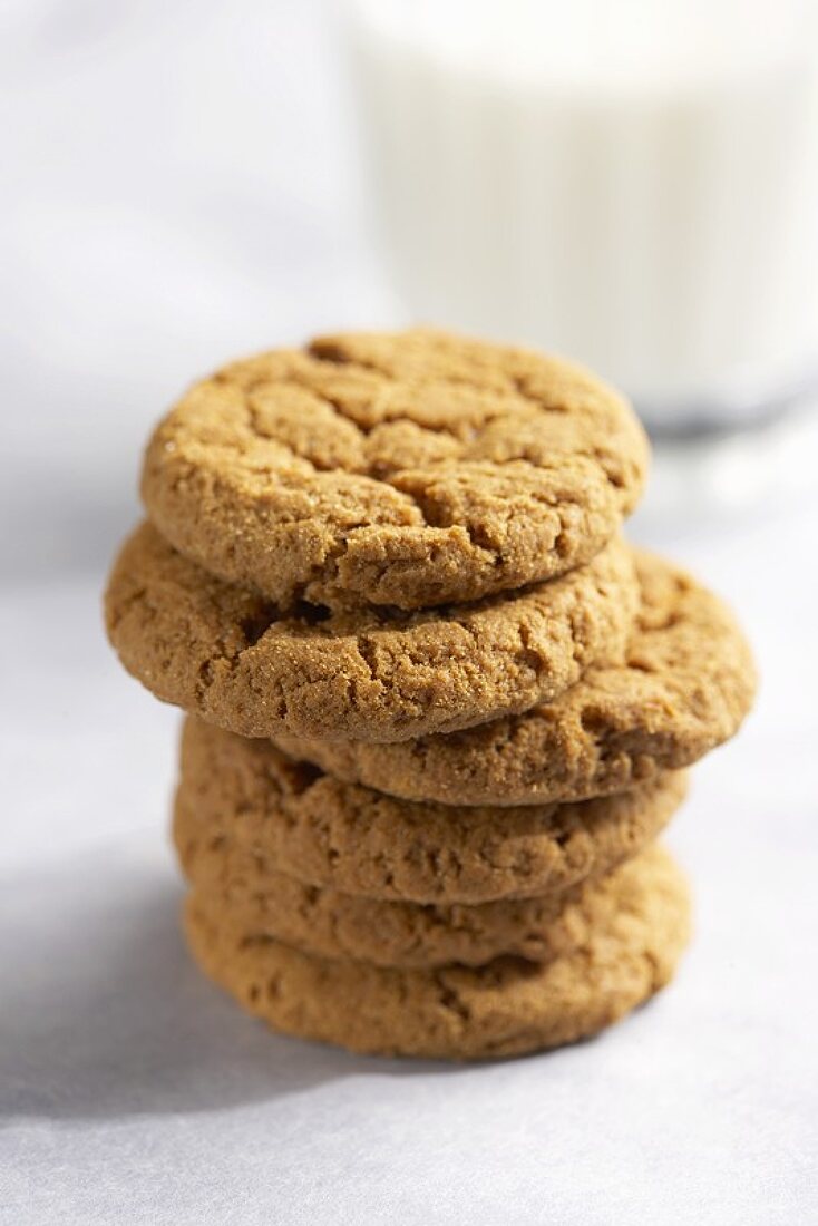 A Stack of Ginger Snaps with a Glass of Milk