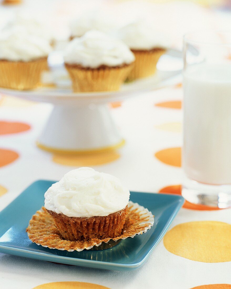 Carrot Cake Cupcake on a Plate with Foil Cup Peeled Back
