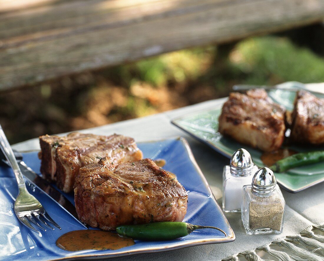 Lamb Chops with Spicy Thai Peanut Sauce on an Outdoor Table