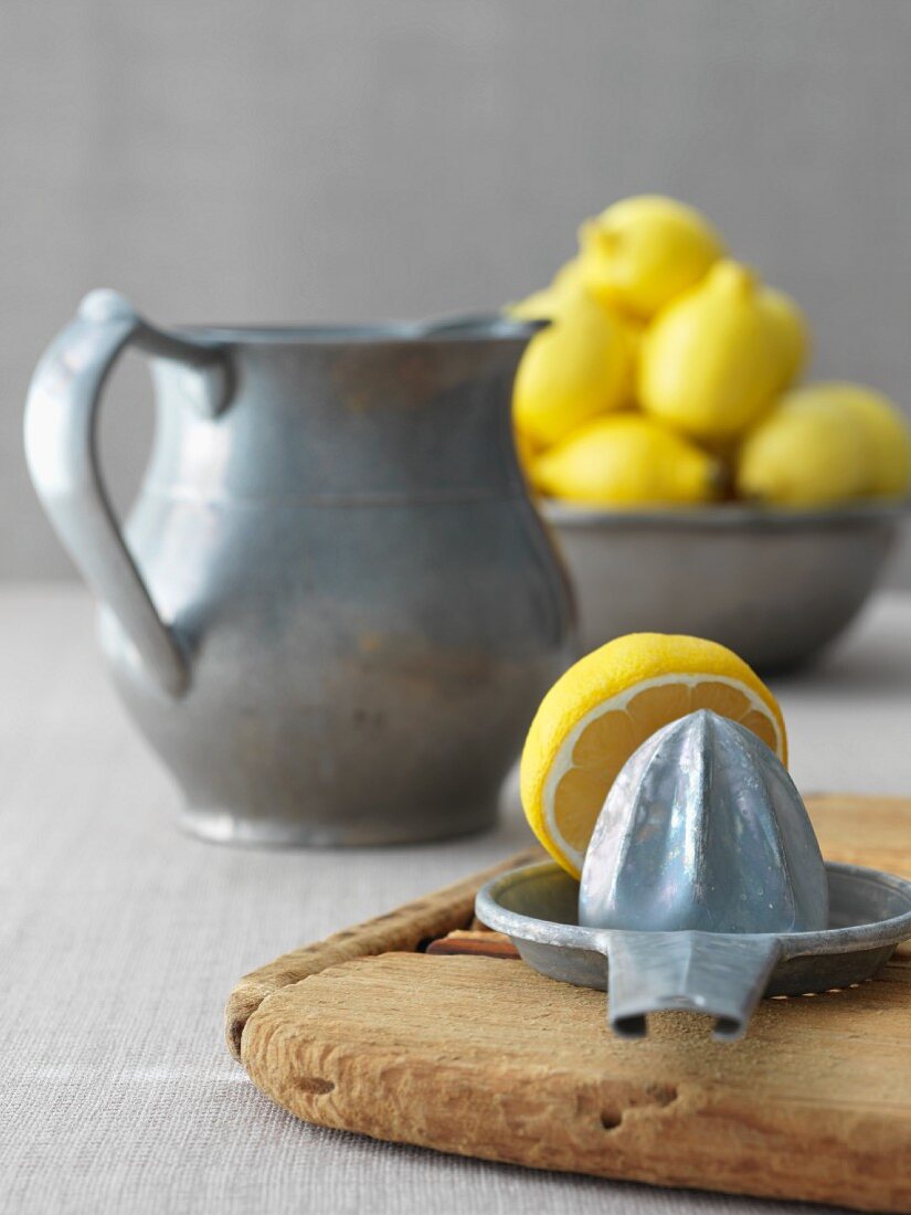 Juicer with Lemon Half; Pitcher and Lemons