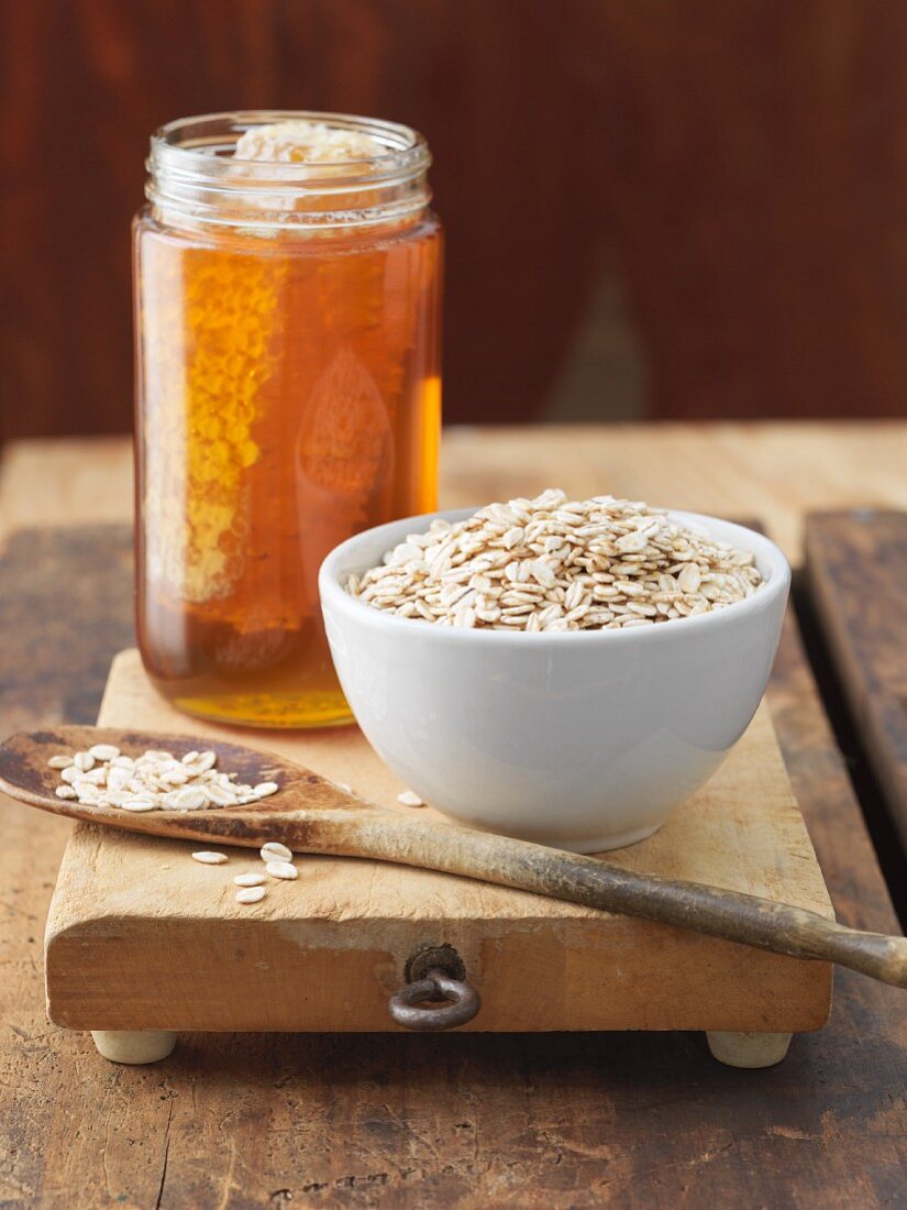 Bowl of Oats with Jar of Honey