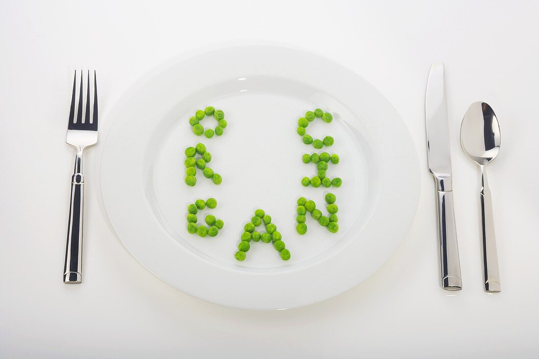 The Word Organic Spelled Out in Peas on a White Dinner Plate