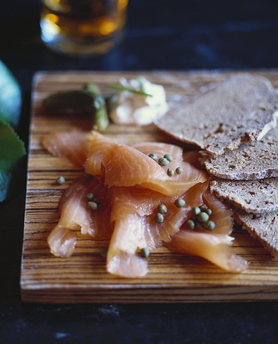 Smoked Salmon with Capers and Bread on Board