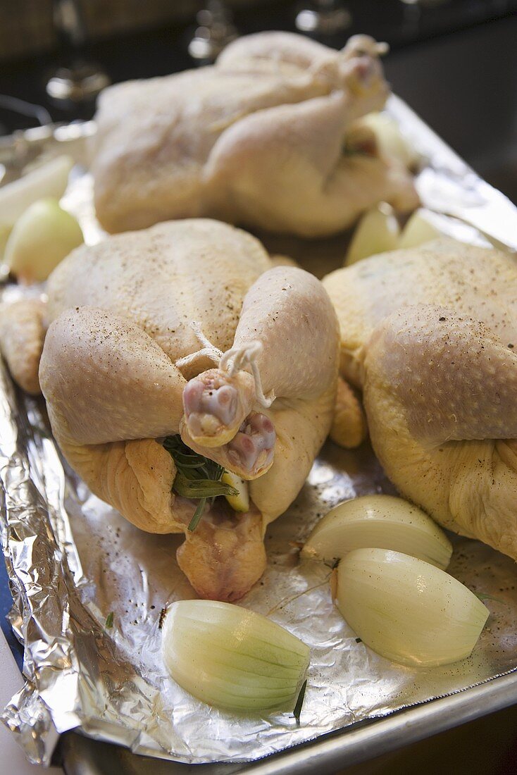 Three Whole Roasting Chickens Prepared on a Pan